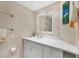 Bright bathroom featuring a white vanity, sink, and framed mirror, complemented by a neutral color scheme at 4401 Gulf Of Mexico Dr # 907, Longboat Key, FL 34228