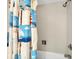 Cozy bathroom featuring a shower with a themed curtain, offering a unique and functional space at 4401 Gulf Of Mexico Dr # 907, Longboat Key, FL 34228
