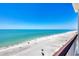 Expansive beach view showcasing turquoise waters and pristine white sand from a high-rise balcony at 4401 Gulf Of Mexico Dr # 907, Longboat Key, FL 34228