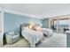 Light and airy bedroom features two twin beds and a seating area with a beautiful balcony view at 4401 Gulf Of Mexico Dr # 907, Longboat Key, FL 34228
