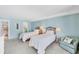 Bedroom featuring two twin beds, carpeted floor, and coastal decor at 4401 Gulf Of Mexico Dr # 907, Longboat Key, FL 34228