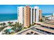 Building exterior with manicured landscaping, community pool, covered parking, and beach access at 4401 Gulf Of Mexico Dr # 907, Longboat Key, FL 34228