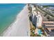 Stunning coastal view of white sand beach and high-rise condos along a scenic shoreline at 4401 Gulf Of Mexico Dr # 907, Longboat Key, FL 34228