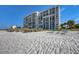 Beautiful luxury condominium complex located right on the beach, with palm trees nearby at 4401 Gulf Of Mexico Dr # 907, Longboat Key, FL 34228