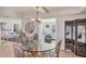 Light-filled dining room adjacent to living room with glass table and decorated accent screen at 4401 Gulf Of Mexico Dr # 907, Longboat Key, FL 34228
