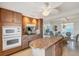 Open kitchen with stainless steel appliances and granite island leads to the dining room at 4401 Gulf Of Mexico Dr # 907, Longboat Key, FL 34228