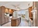 Spacious kitchen with granite countertops, tan cabinetry, stainless appliances, and a center island at 4401 Gulf Of Mexico Dr # 907, Longboat Key, FL 34228