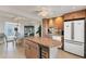 Bright kitchen featuring granite countertops, stainless steel appliances, and center island with a beverage refrigerator at 4401 Gulf Of Mexico Dr # 907, Longboat Key, FL 34228