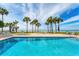 Gorgeous pool area with palm trees, perfect for swimming with relaxing ocean views from the property at 4401 Gulf Of Mexico Dr # 907, Longboat Key, FL 34228