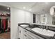Elegant bathroom featuring a double vanity, large mirror, and a walk-in closet at 4600 Gulf Of Mexico Dr # 201, Longboat Key, FL 34228