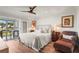 Relaxing bedroom featuring a comfortable king bed, balcony with sea view, and elegant decor at 4600 Gulf Of Mexico Dr # 201, Longboat Key, FL 34228