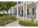 Inviting front porch with classic columns and a well-manicured garden, exuding charm and curb appeal at 471 Gilman N Ct, St Petersburg, FL 33716