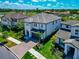 An aerial view of a two-story home with lush landscaping, paved driveway, and two-car garage at 4881 Antrim Dr, Sarasota, FL 34240