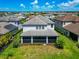 An aerial view features a two-story home with lush greenery, a tile roof, and a screened-in lanai at 4881 Antrim Dr, Sarasota, FL 34240