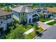 Aerial view of a neighborhood with a two-story home with a tiled roof, green grass and sidewalk at 4881 Antrim Dr, Sarasota, FL 34240