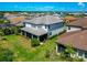 Aerial view of a two-story home with a screened-in lanai and lush green lawn in a neighborhood at 4881 Antrim Dr, Sarasota, FL 34240