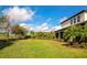 Lush backyard featuring mature trees and a well-manicured lawn at 4881 Antrim Dr, Sarasota, FL 34240
