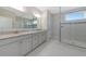 Elegant bathroom featuring double vanity, granite countertops, and a glass-enclosed shower with modern fixtures at 4881 Antrim Dr, Sarasota, FL 34240