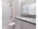 Bright bathroom featuring a shower over tub and granite countertop at 4881 Antrim Dr, Sarasota, FL 34240