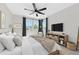 Modern bedroom with hardwood floors, a large window, and a ceiling fan, offering comfort and style at 4881 Antrim Dr, Sarasota, FL 34240