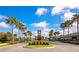 Gated community entrance with lush landscaping and palm trees at 4881 Antrim Dr, Sarasota, FL 34240