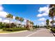 Community entrance with manicured landscaping and palm trees at 4881 Antrim Dr, Sarasota, FL 34240