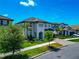 Two-story home with a two-car garage, well-manicured landscaping, and a brick paved driveway at 4881 Antrim Dr, Sarasota, FL 34240