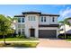 Two-story home boasts a two-car garage, tiled roof, well-maintained lawn, and professional landscaping at 4881 Antrim Dr, Sarasota, FL 34240