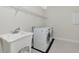 Spacious laundry room with a sink and modern washer and dryer at 4881 Antrim Dr, Sarasota, FL 34240