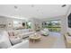 A stylish living room is filled with modern furnishings and natural light at 4881 Antrim Dr, Sarasota, FL 34240
