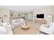 A well-lit living room on the second floor features a cozy sitting area and open layout, perfect for entertaining guests at 4881 Antrim Dr, Sarasota, FL 34240