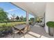 Expansive outdoor patio with dining and lounge areas, overlooking the beautifully landscaped backyard with lush greenery at 4881 Antrim Dr, Sarasota, FL 34240