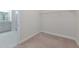 Unfurnished walk-in closet leading to the bathroom with neutral finishes, providing ample storage space at 4881 Antrim Dr, Sarasota, FL 34240
