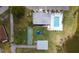 Aerial of community pool, shuffleboard courts, and parking near a lake at 5053 Live Oak Cir, Bradenton, FL 34207