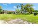Lush backyard featuring green grass, a patio, and landscaping beneath a blue sky at 5053 Live Oak Cir, Bradenton, FL 34207