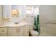 Clean bathroom with a single sink vanity, toilet, and a shower-tub combo with green-leaf shower curtain at 5053 Live Oak Cir, Bradenton, FL 34207