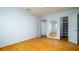 Bedroom with hardwood flooring, a closet, and adjacent access to a mirrored bathroom area at 5053 Live Oak Cir, Bradenton, FL 34207