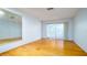 Bright bedroom with hardwood floors and a glass sliding door to a sun room at 5053 Live Oak Cir, Bradenton, FL 34207