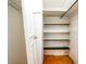 A closet space with multiple shelves and a hanging rod for organized storage solutions at 5053 Live Oak Cir, Bradenton, FL 34207