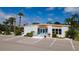 Community building exterior with ample parking and landscaping, plus a glimpse of the community pool at 5053 Live Oak Cir, Bradenton, FL 34207