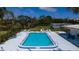 Aerial view of the pool with lounge chairs, a fence, and manicured landscaping at 5053 Live Oak Cir, Bradenton, FL 34207