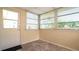 Inviting sunroom featuring ample windows, tile floor, and an entrance door at 5053 Live Oak Cir, Bradenton, FL 34207