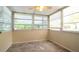 Bright sunroom enclosed with many windows providing natural light and garden views at 5053 Live Oak Cir, Bradenton, FL 34207