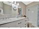 Bright bathroom with a double sink vanity, granite countertops, modern fixtures, and plenty of storage at 5307 1St Avenue Nw Dr, Bradenton, FL 34209