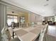 Open-concept dining room featuring stylish chairs, a modern table, and sliding glass doors to the outdoor patio at 5307 1St Avenue Nw Dr, Bradenton, FL 34209