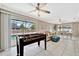 Spacious recreation room with foosball table, comfortable seating, and access to screened-in pool area at 5307 1St Avenue Nw Dr, Bradenton, FL 34209