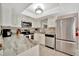 Updated kitchen features white cabinets, stainless steel appliances, and gray countertops at 5307 1St Avenue Nw Dr, Bradenton, FL 34209