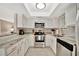 Modern kitchen with white cabinets, stainless steel appliances, and ample counter space at 5307 1St Avenue Nw Dr, Bradenton, FL 34209