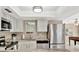 Bright kitchen offers stainless steel appliances, white cabinets and a view to the Gathering room at 5307 1St Avenue Nw Dr, Bradenton, FL 34209