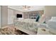 Bright main bedroom featuring a decorative ceiling fan, beachy decor, and sliding glass doors at 5307 1St Avenue Nw Dr, Bradenton, FL 34209